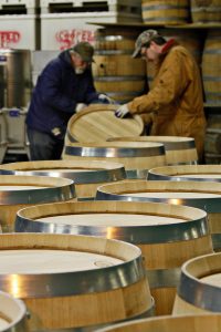 Two employees complete a final sanding by hand of oak wine barrels produced on Dec. 9th at A & K Cooperage in Higbee, MO. The cooperage has been owned and operated by the Kerby family for three generations and produces around 5000 barrels a year.