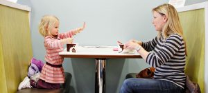 Carly Meyer, 3, shows off clean hands while enjoying a cup of frozen yogurt with her mother, Chrissy, on Tuesday afternoon, January 18, at the new Red Mango in downtown Columbia. Commenting on the yogurt shop, Chrissy Meyer said, “I’m so glad they have one here now."